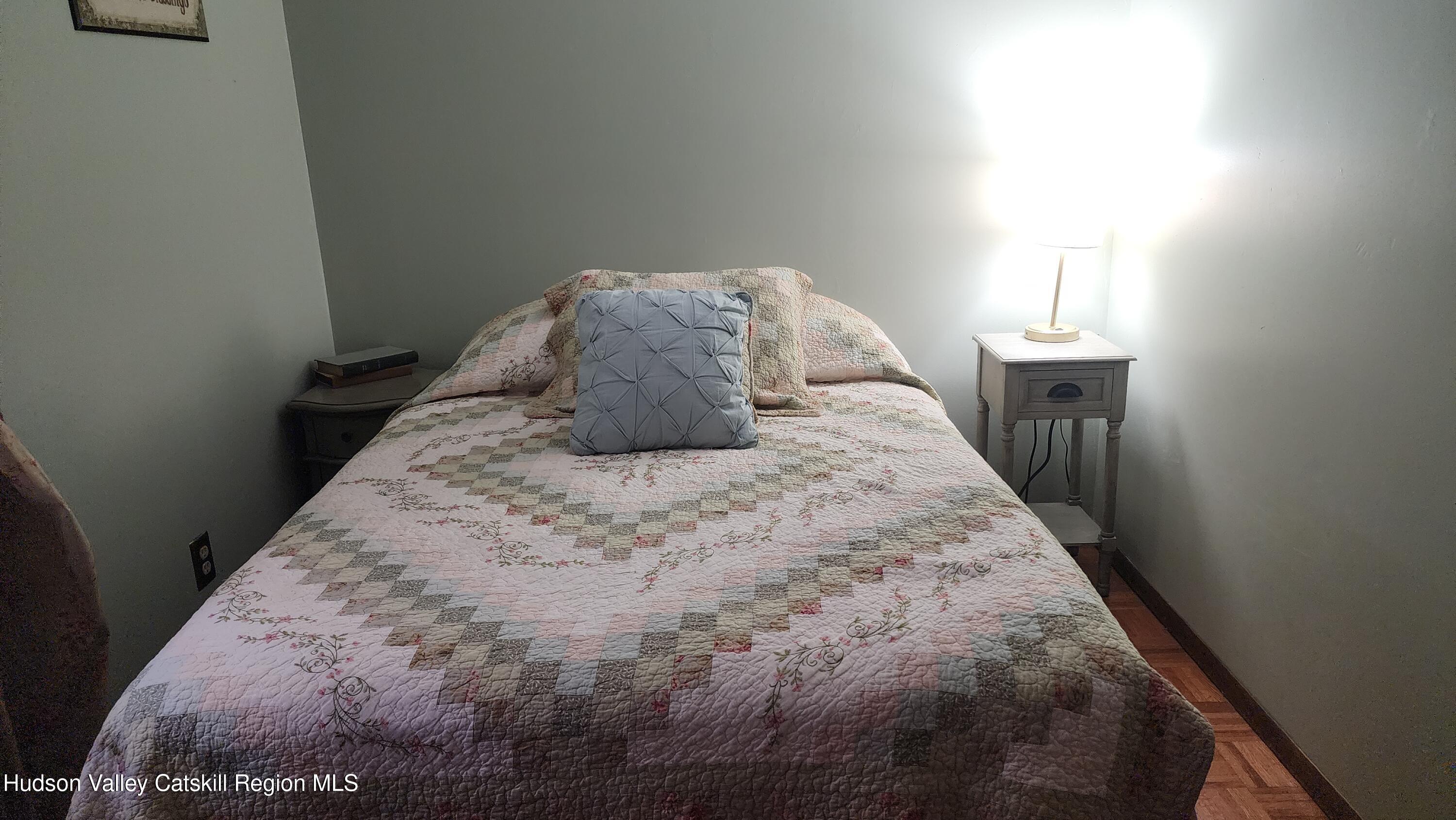 17 Clay Hill Road Durham, NY 12423 - Photo 10 of 15 a large bed sitting in a bedroom next to a window