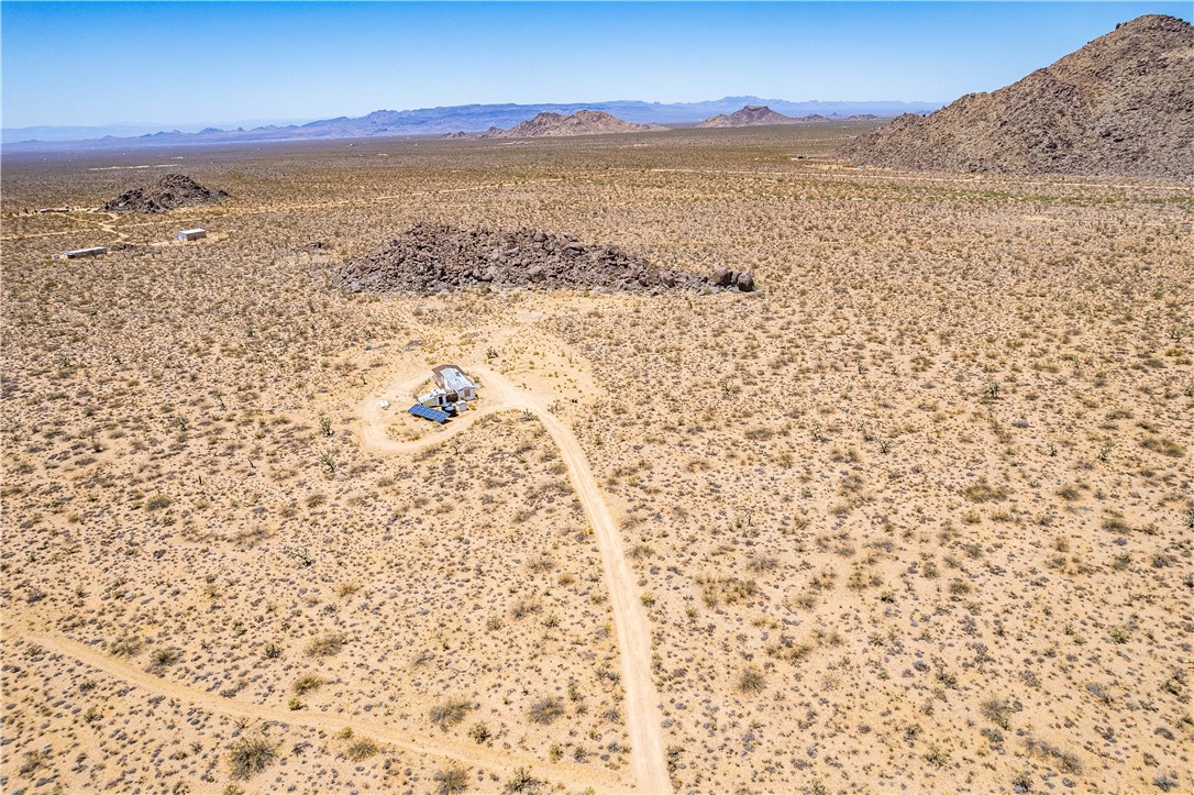 16435 South Wyatt Earp Road Yucca, AZ 86438 - Photo 43 of 57 Expansive desert landscape featuring a central dwelling with a dirt access road