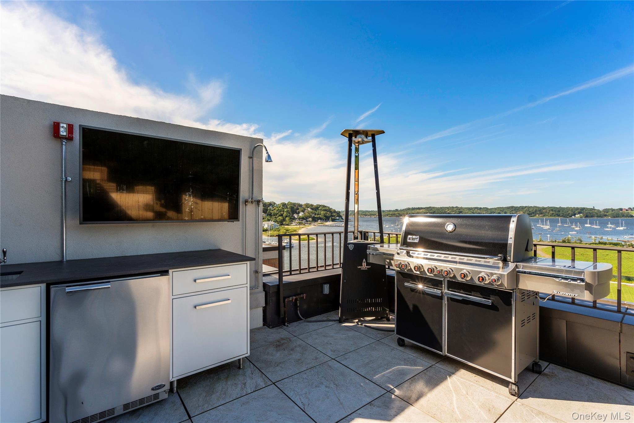 100 Garvies Point Road, Unit 1309 Glen Cove, NY 11542 - Photo 18 of 36 View of rooftop terrace with an outdoor kitchen and a water view