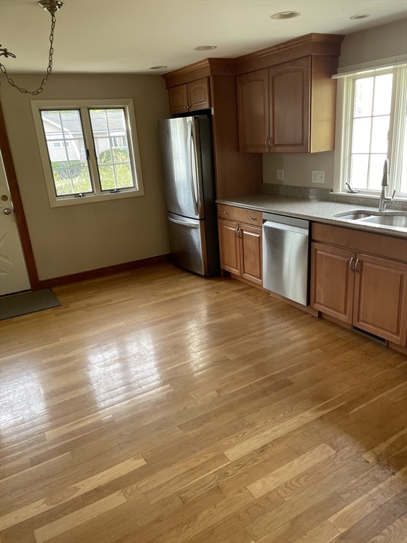 100 Francis Wyman Road Burlington, MA 01803 - Photo 4 of 17 a kitchen with granite countertop a stove a sink and a refrigerator