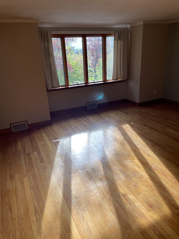 100 Francis Wyman Road Burlington, MA 01803 - Photo 5 of 17 a view of an empty room with wooden floor and a window