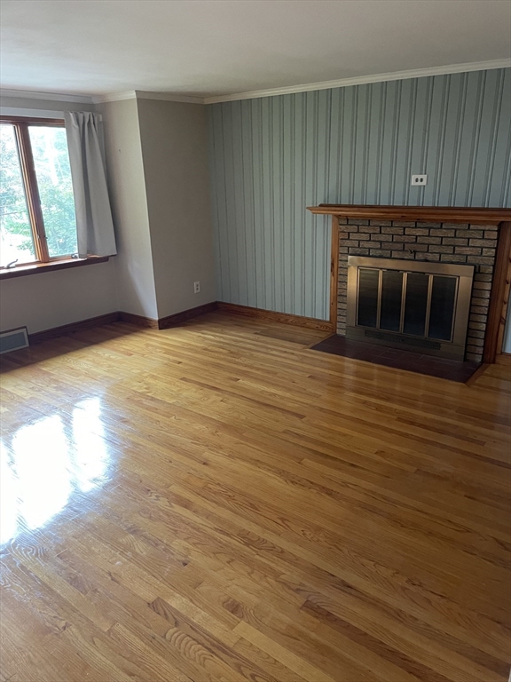 100 Francis Wyman Road Burlington, MA 01803 - Photo 8 of 17 an empty room with wooden floor fireplace and windows