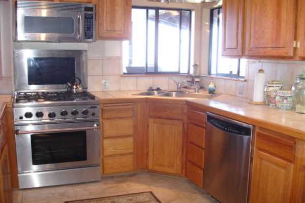 82-1064 Kiloa Road Captain Cook, HI 96704 - Photo 3 of 22 a kitchen with a stove and a sink