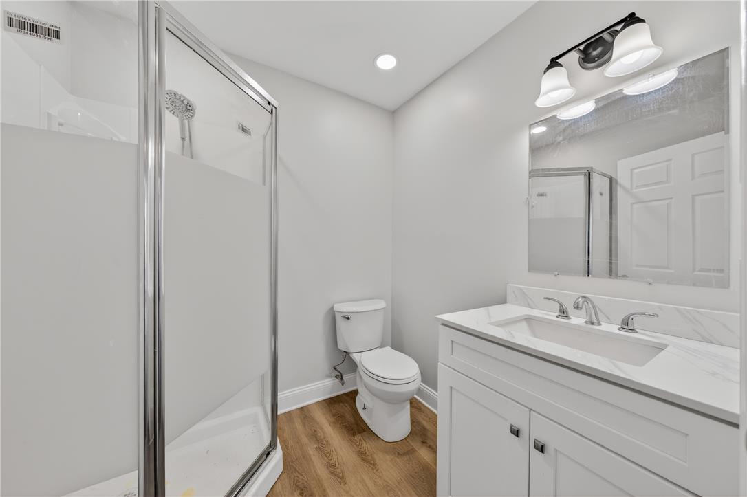 65 2nd Street Slatington, PA 18080 - Photo 13 of 46 This sleek bathroom boasts a single vanity and a convenient stand-up shower, creating a fresh and modern aesthetic.