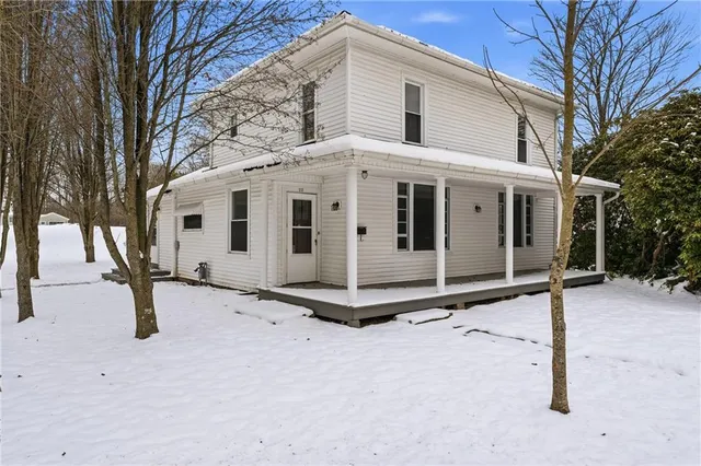 a view of a white house with a yard