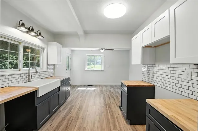 a spacious bathroom with a double vanity sink a mirror and a bathtub