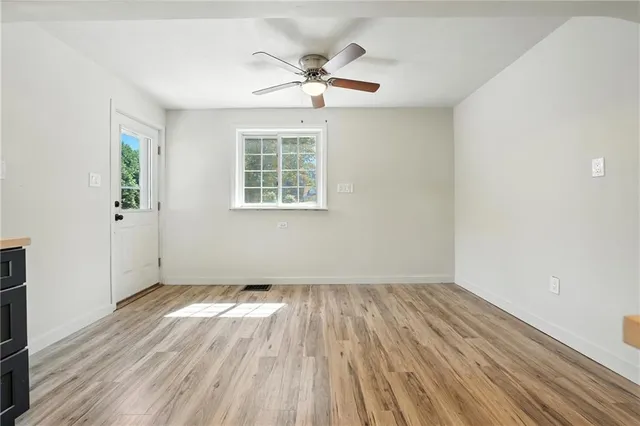 wooden floor in an empty room with a window
