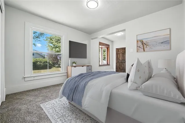 a bed room with a bed and a window