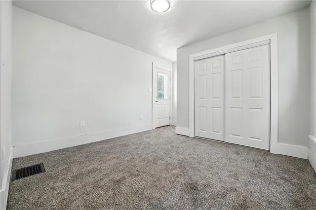 an empty room with closet area
