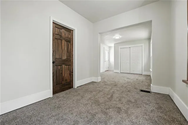 an empty room with windows and closet