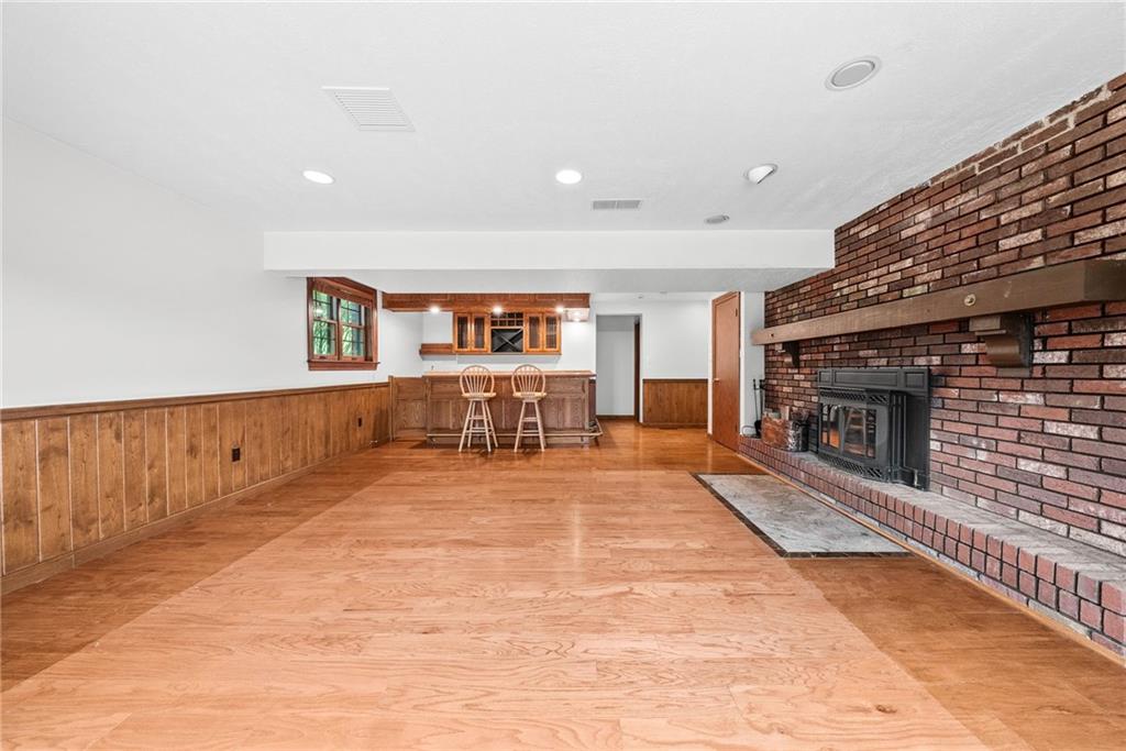 94 Ohare Road Canonsburg, PA 15317 - Photo 36 of 50 Spacious game room with a full brick fireplace and built-in bar, creating an ideal space for entertaining.