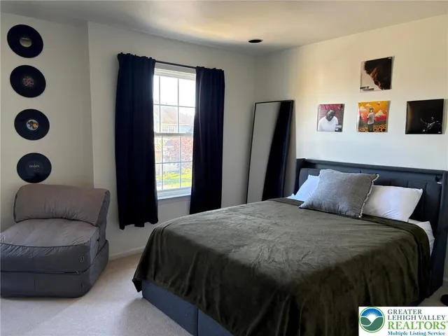 a bed sitting in a bedroom next to a window