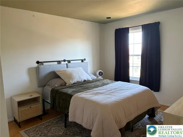 a bedroom with a bed and a window