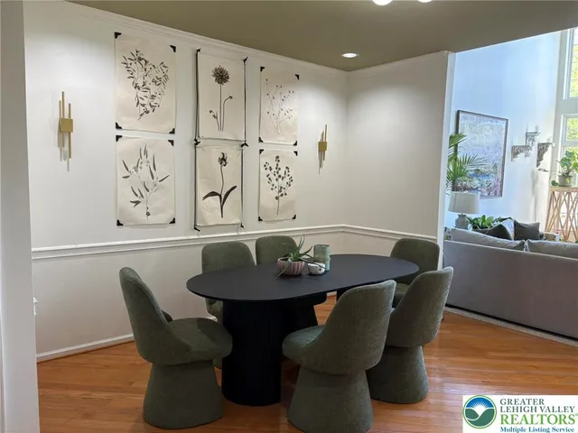 a dining room with furniture and wooden floor