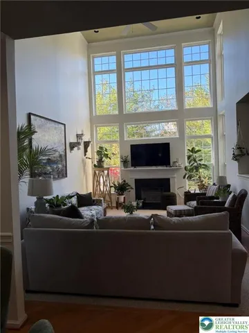 a living room with furniture a fireplace and a flat screen tv