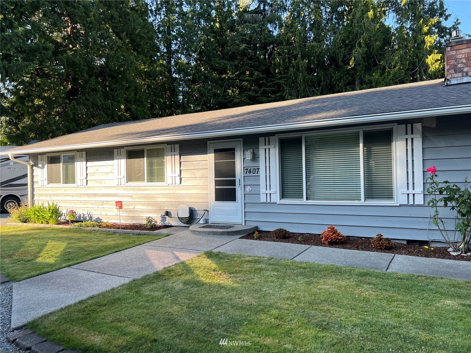 7407 Vandermark Road East Bonney Lake, WA 98391 - Photo 1 of 30 a front view of a house with a garden and patio