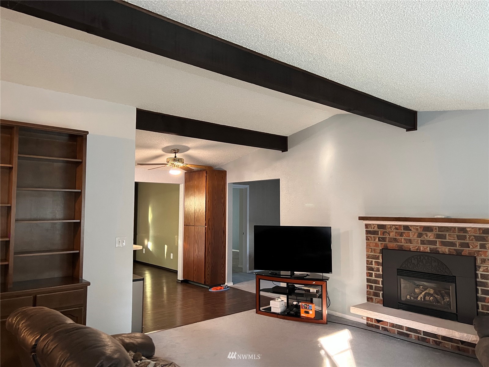 7407 Vandermark Road East Bonney Lake, WA 98391 - Photo 3 of 30 a view of a livingroom with furniture and a fireplace