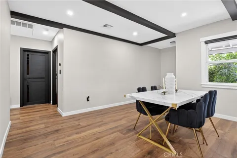 a view of a workspace with furniture and wooden floor