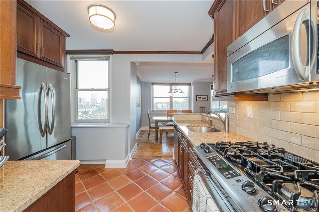 50 Glenbrook Road, Unit 6E Stamford, CT 06902 - Photo 10 of 18 a kitchen with granite countertop a stove and a refrigerator
