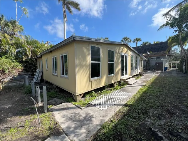 a couple of palm trees in front of house