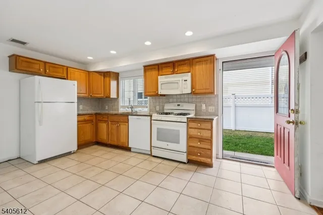 a kitchen with a refrigerator and a stove top oven