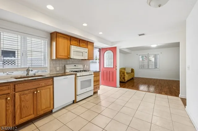 a kitchen with a sink cabinets and window