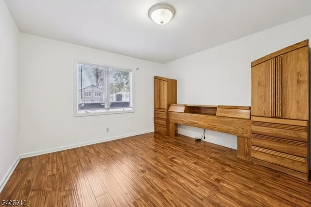 a living room with wooden floor and furniture