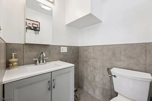 a bathroom with a sink mirror vanity and toilet
