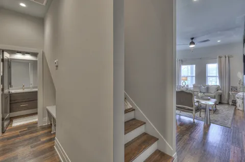 a view of a livingroom with wooden floor and furniture