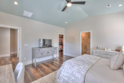 a bedroom with a bed and a chandelier