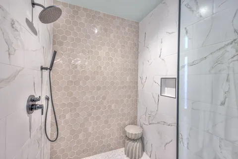 a bathroom with a granite countertop shower and a sink