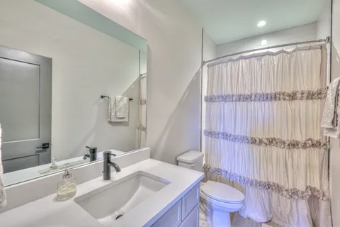 a bathroom with a sink toilet and shower