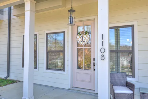 a front view of a house with outdoor seating space