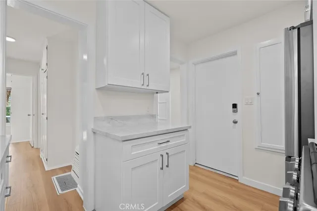 a kitchen with cabinets stainless steel appliances and a window