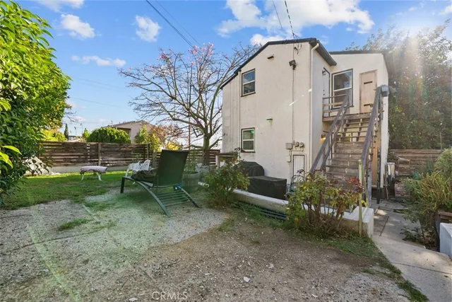 a view of a house with a backyard