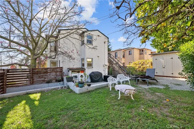 a view of backyard with couches and palm trees