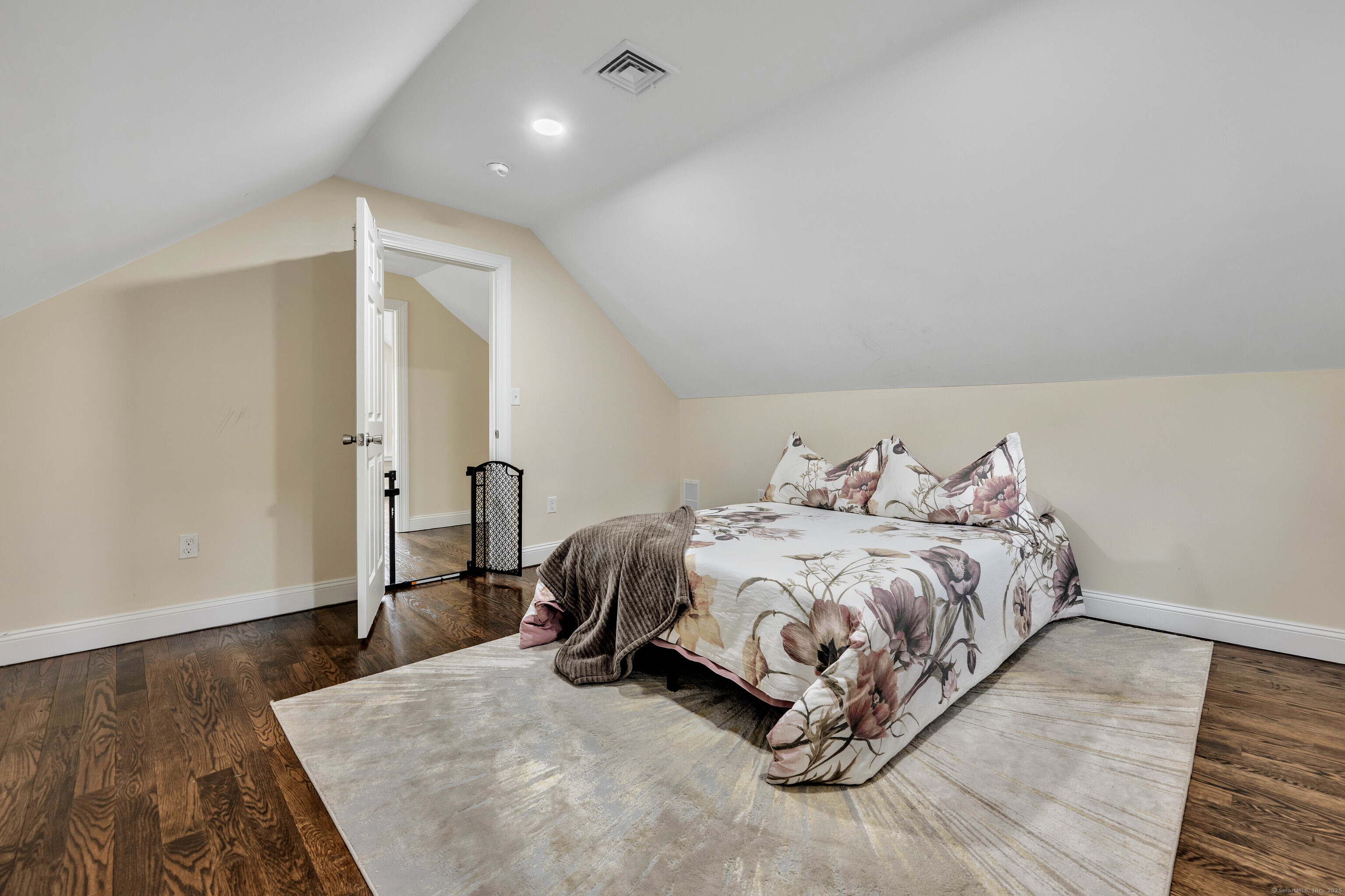 550 New Hanover Avenue Meriden, CT 06451 - Photo 22 of 34 a bed sitting in a spacious bedroom next to a window and a wooden floor