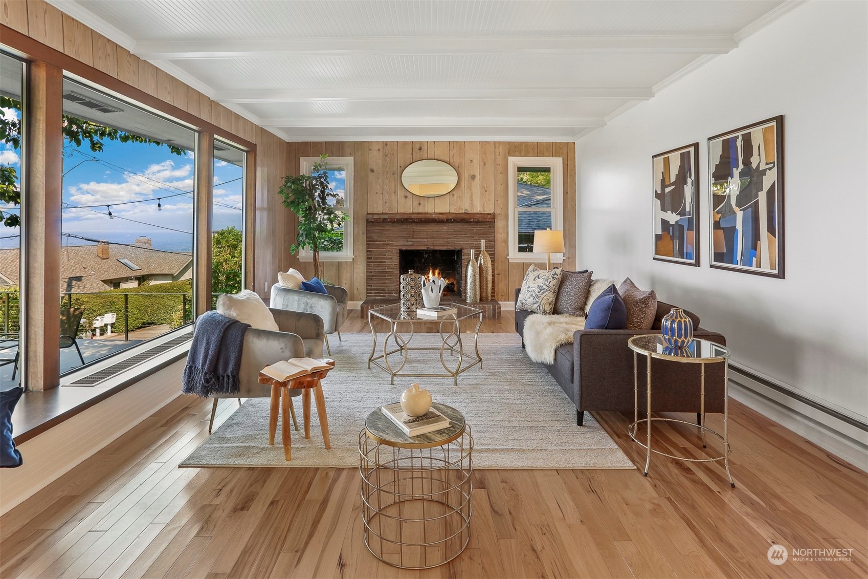 3245 Northwest Esplanade Seattle, WA 98117 - Photo 12 of 38 a living room with furniture a fireplace and a floor to ceiling window