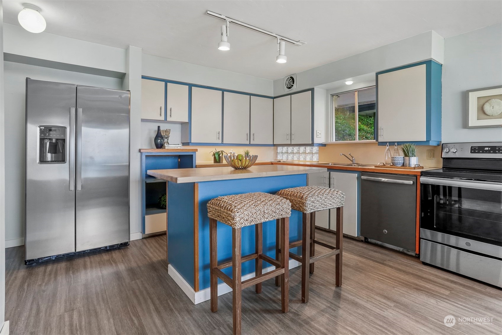 3245 Northwest Esplanade Seattle, WA 98117 - Photo 22 of 38 a kitchen with stainless steel appliances granite countertop a table chairs sink refrigerator and cabinets