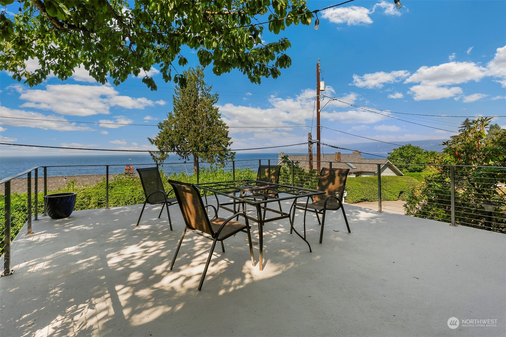 3245 Northwest Esplanade Seattle, WA 98117 - Photo 4 of 38 a view of a patio with a table and chairs under an umbrella