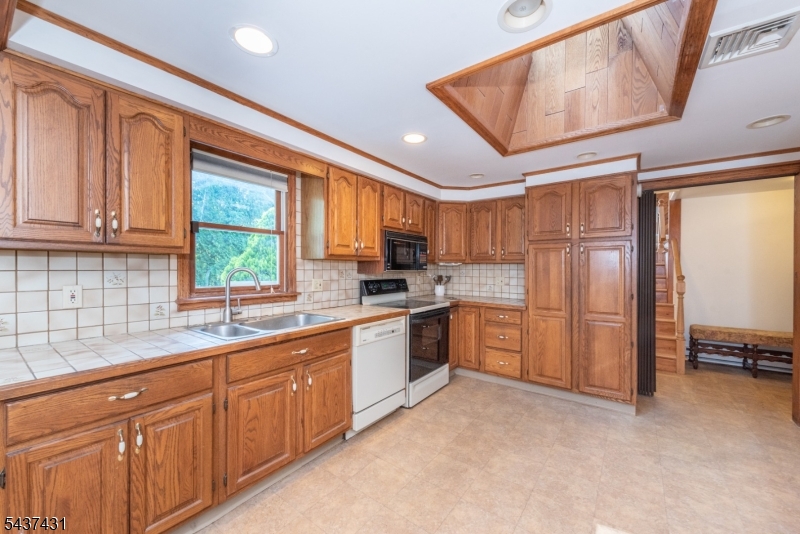 20 Wanaque Road West Milford, NJ 07421 - Photo 8 of 31 a kitchen with stainless steel appliances granite countertop a refrigerator and sink