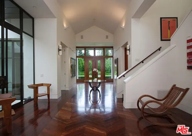 a living room with furniture and a floor to ceiling window