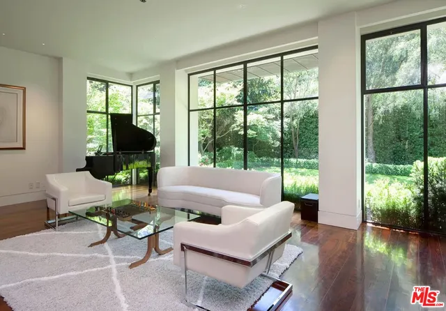 a living room with furniture and a floor to ceiling window