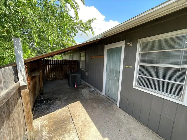 a backyard of a house with table and chairs