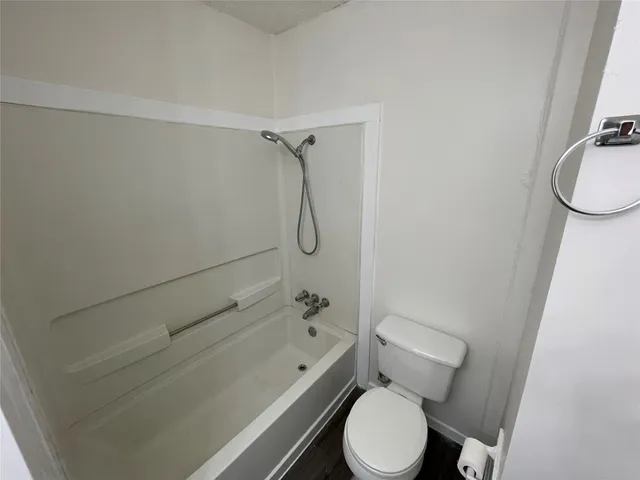 a bathroom with a toilet and a shower