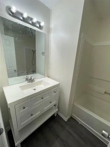 a bathroom with a double vanity sink and a mirror