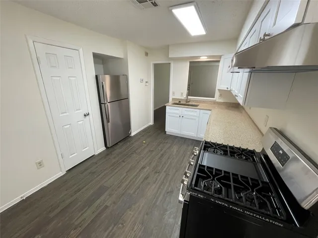 a kitchen with a stove and a refrigerator
