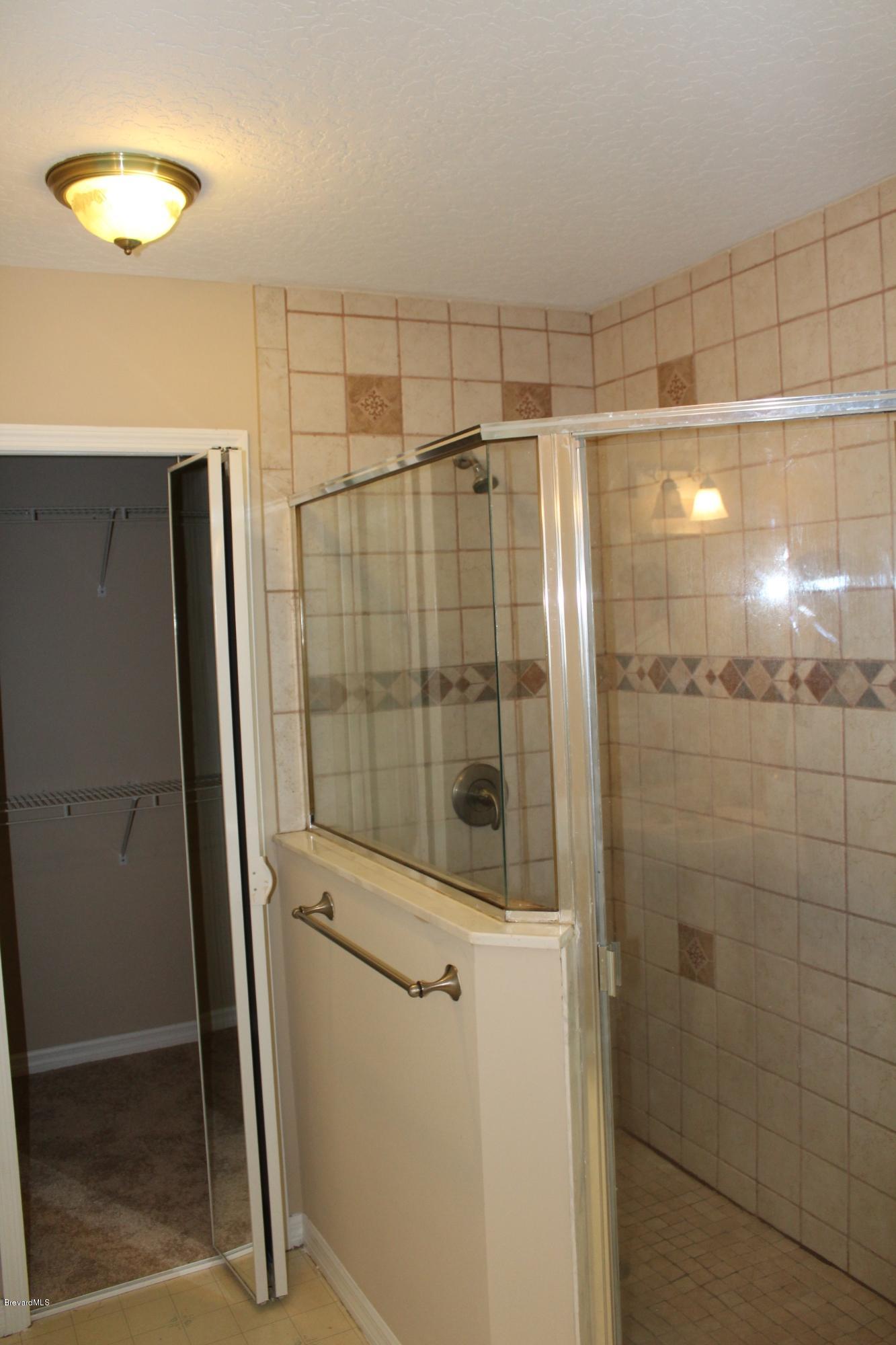 4565 Delespine Road Cocoa, FL 32927 - Photo 12 of 32 Master bath shower & walk-in closet