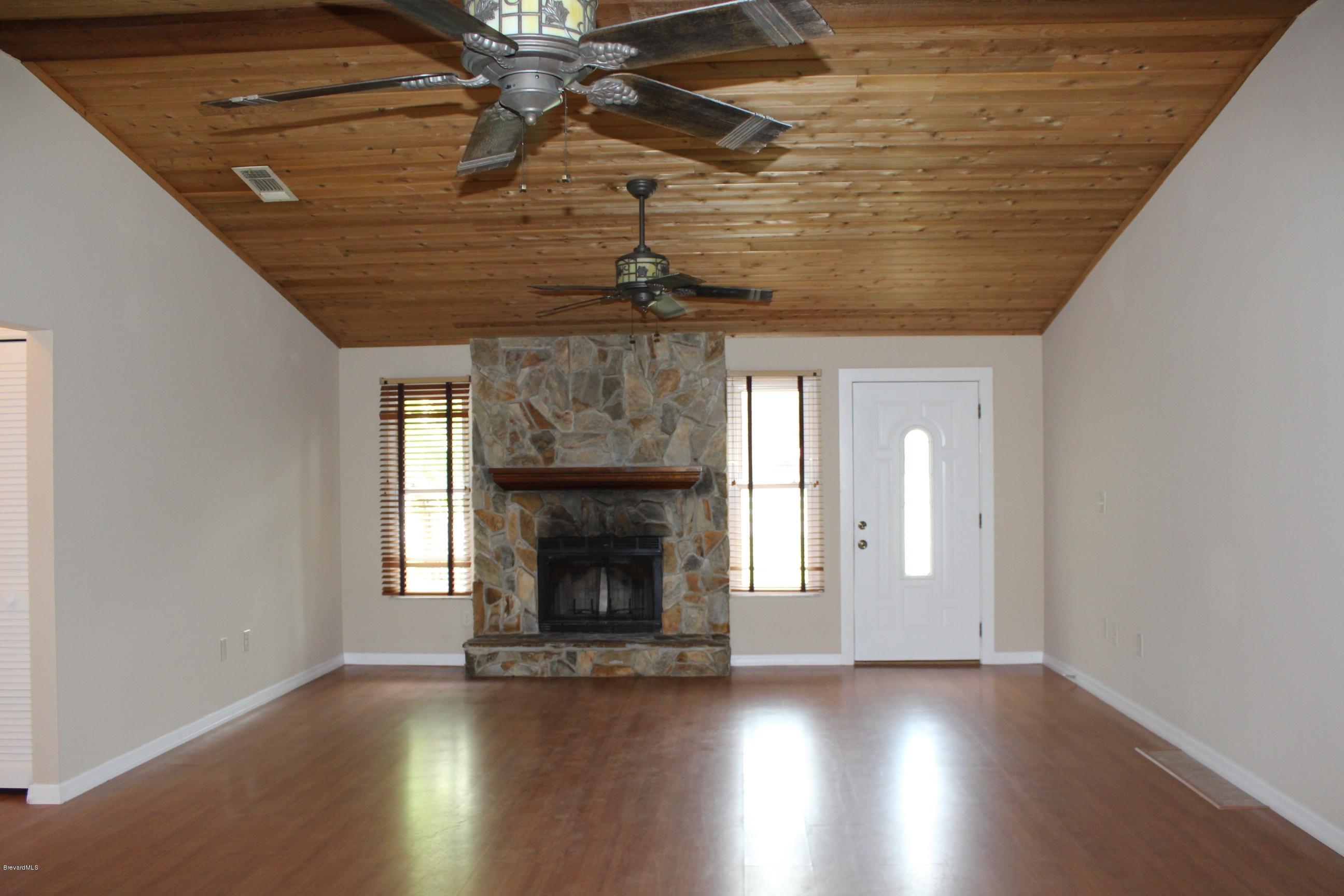4565 Delespine Road Cocoa, FL 32927 - Photo 3 of 32 Living room with wood burning fireplace