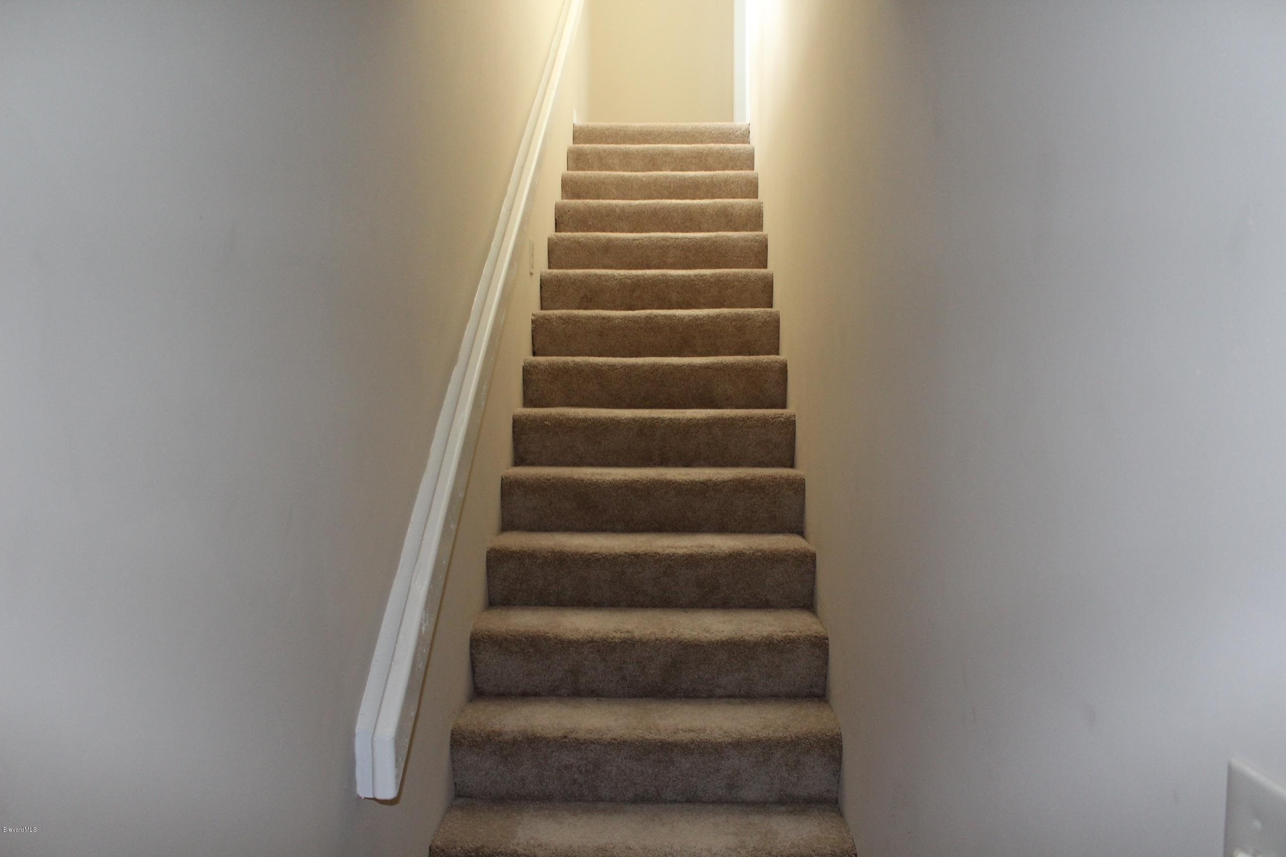 4565 Delespine Road Cocoa, FL 32927 - Photo 7 of 32 New carpeted stairway to master bedroom